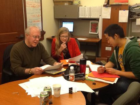 2012 MFA Graduates Andrew Taw and Casey McAlduff review entries with Robert Hass