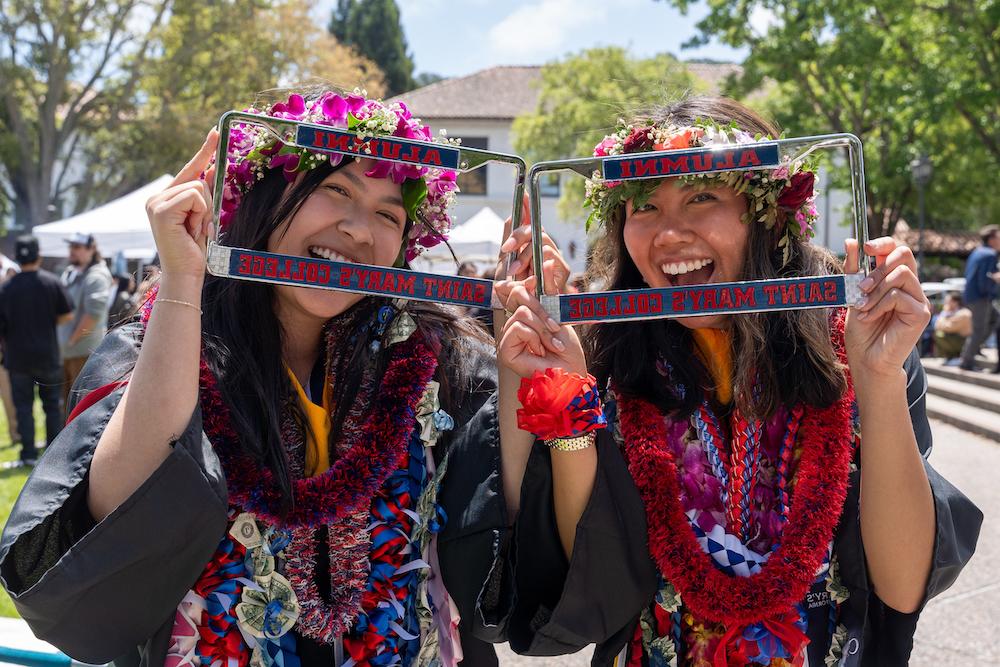 2024年本科毕业典礼后，两名女学生微笑着通过圣玛丽校友车牌持有人